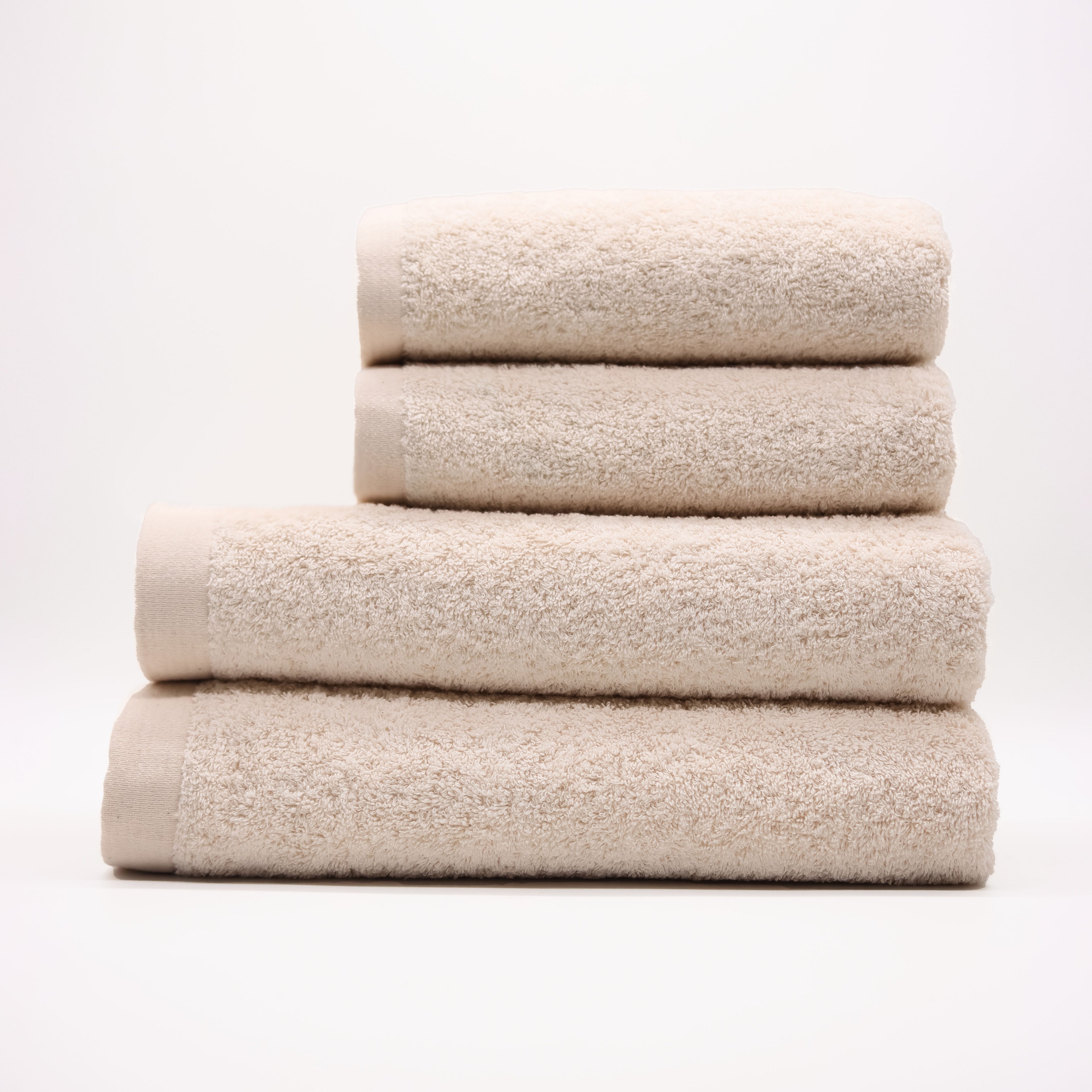 Stack of beige towels on a white background