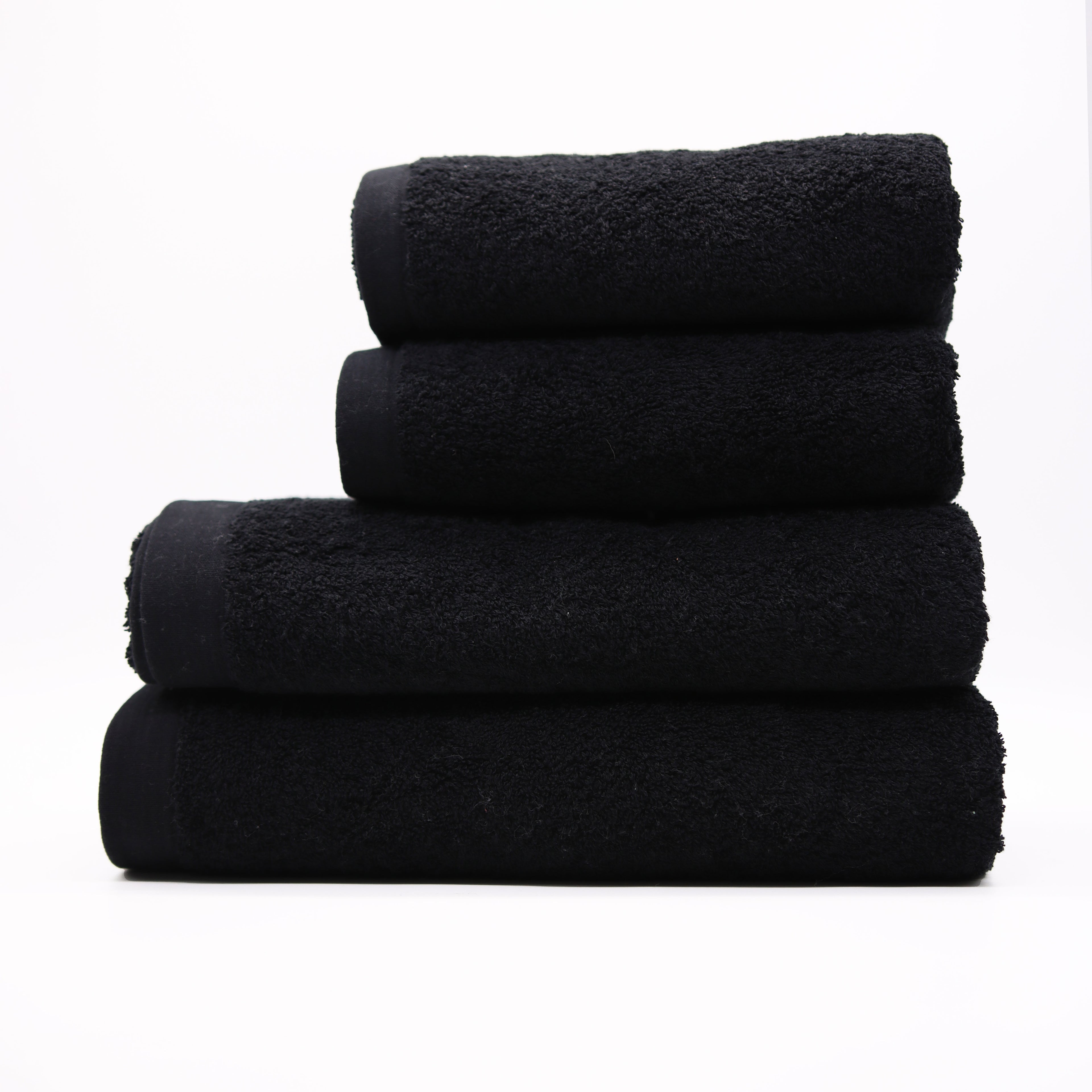 Stack of black towels on a white background