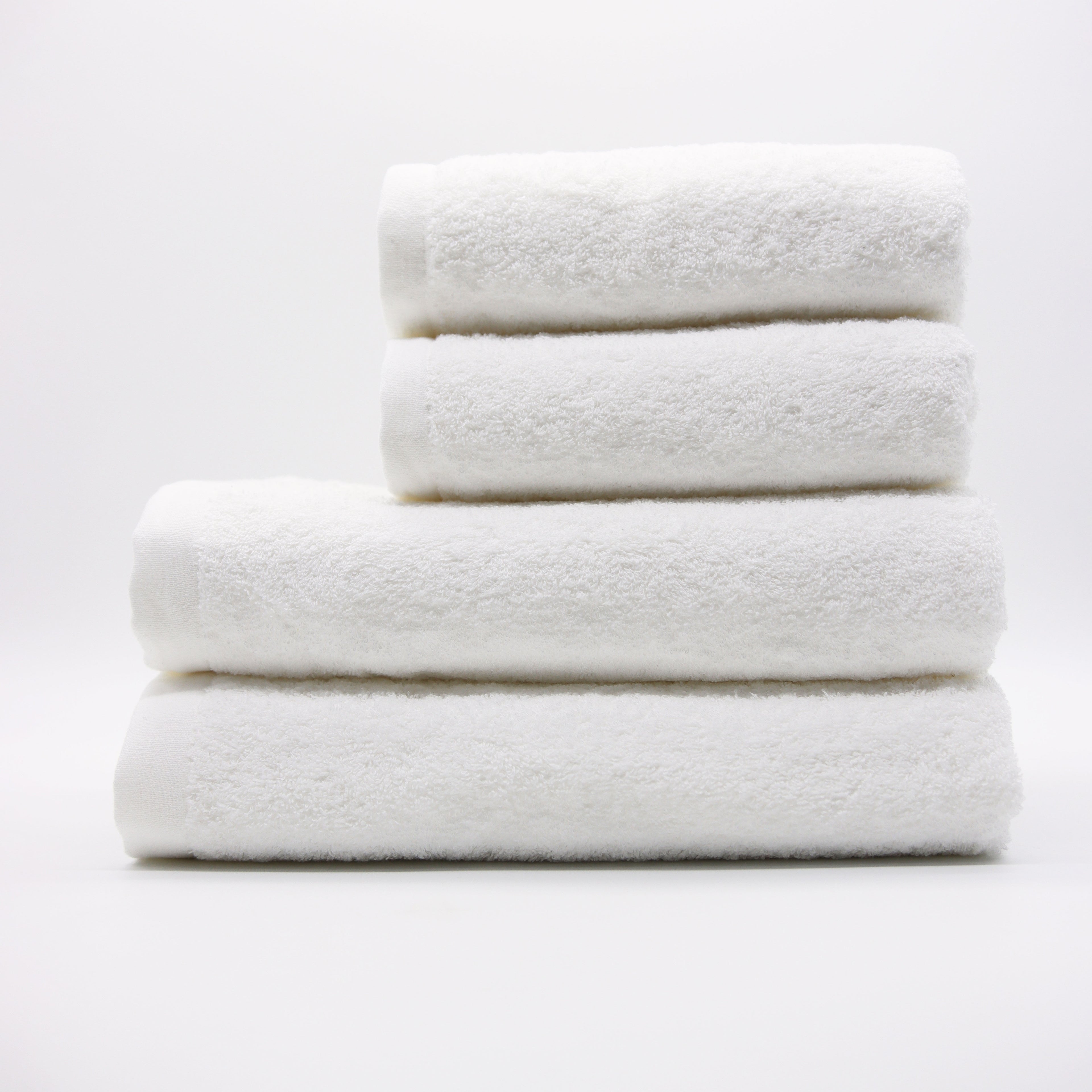 Stack of white towels on a light gray background